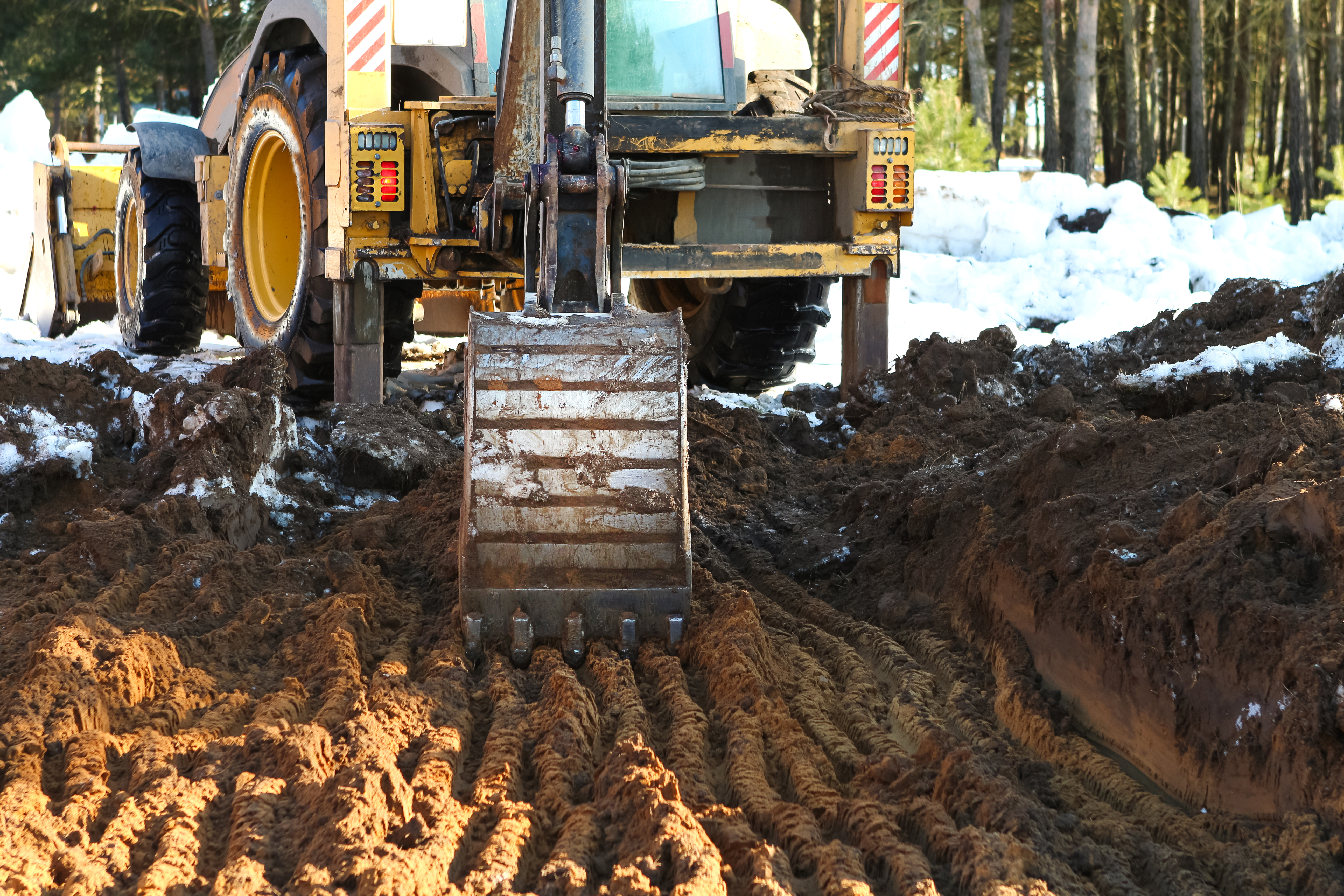 Dozer performing finish grading on a building pad