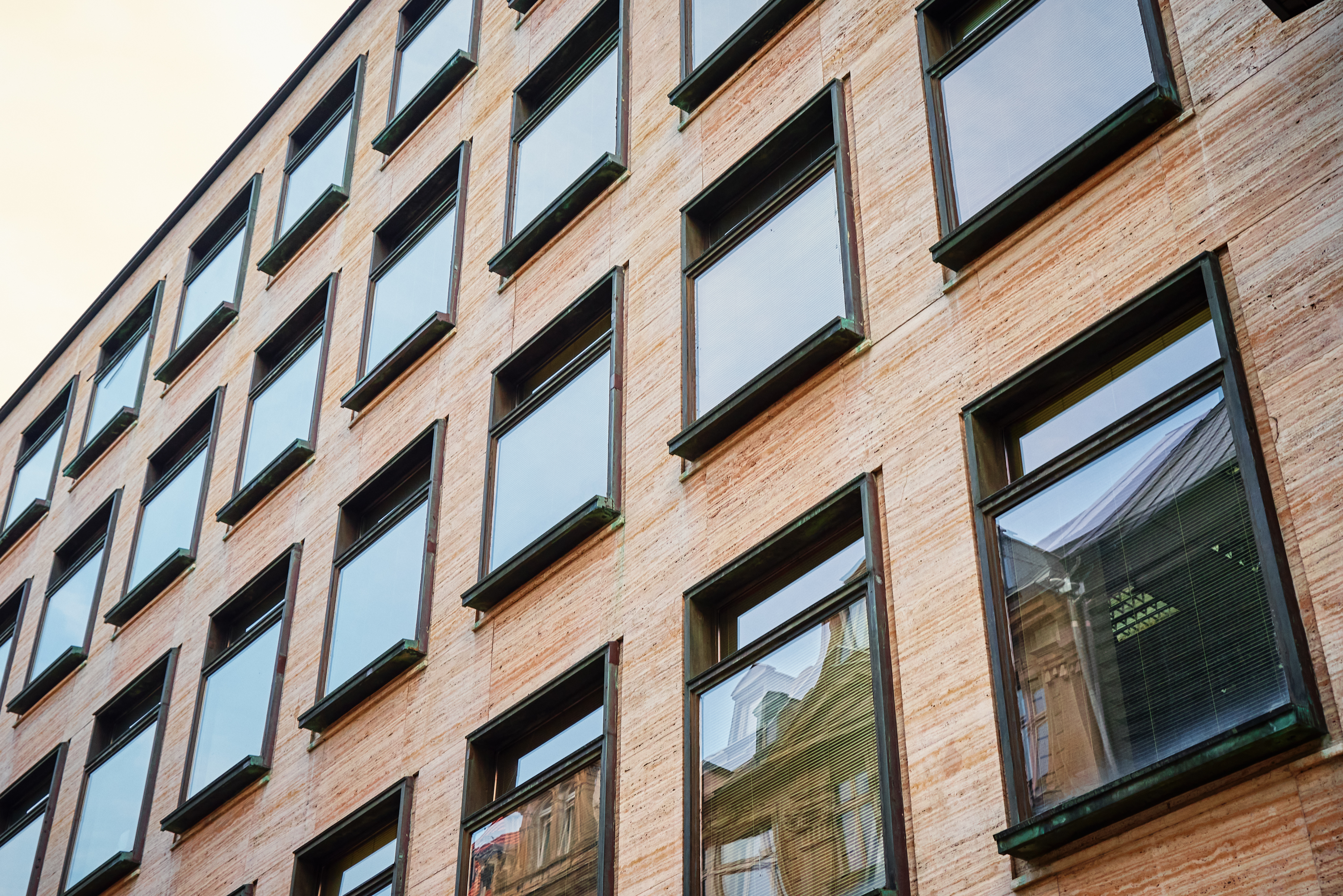 Historic brick industrial building converted to modern use, large windows, restored facade