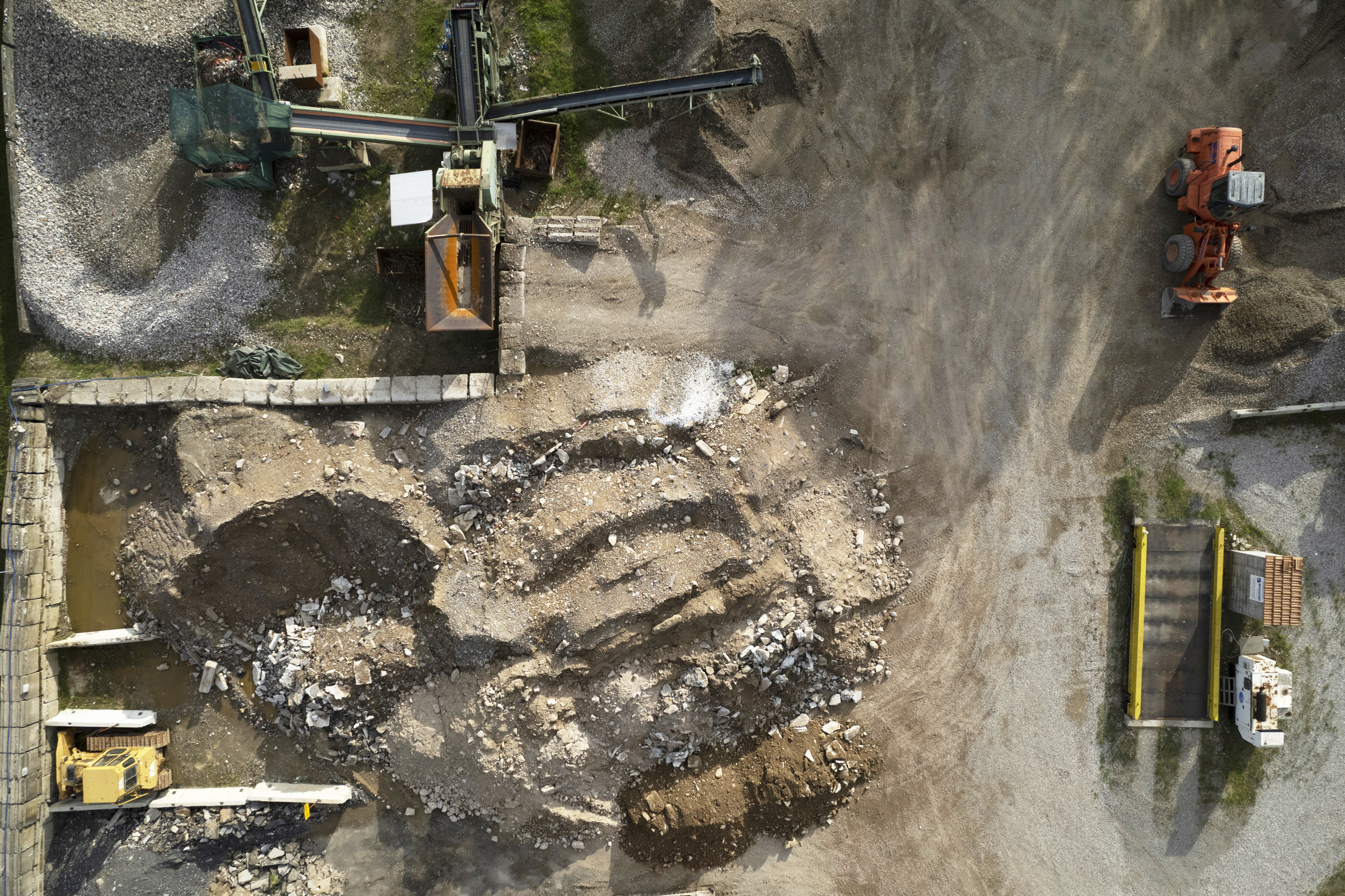 Large site under mass excavation with multiple excavators and haul trucks