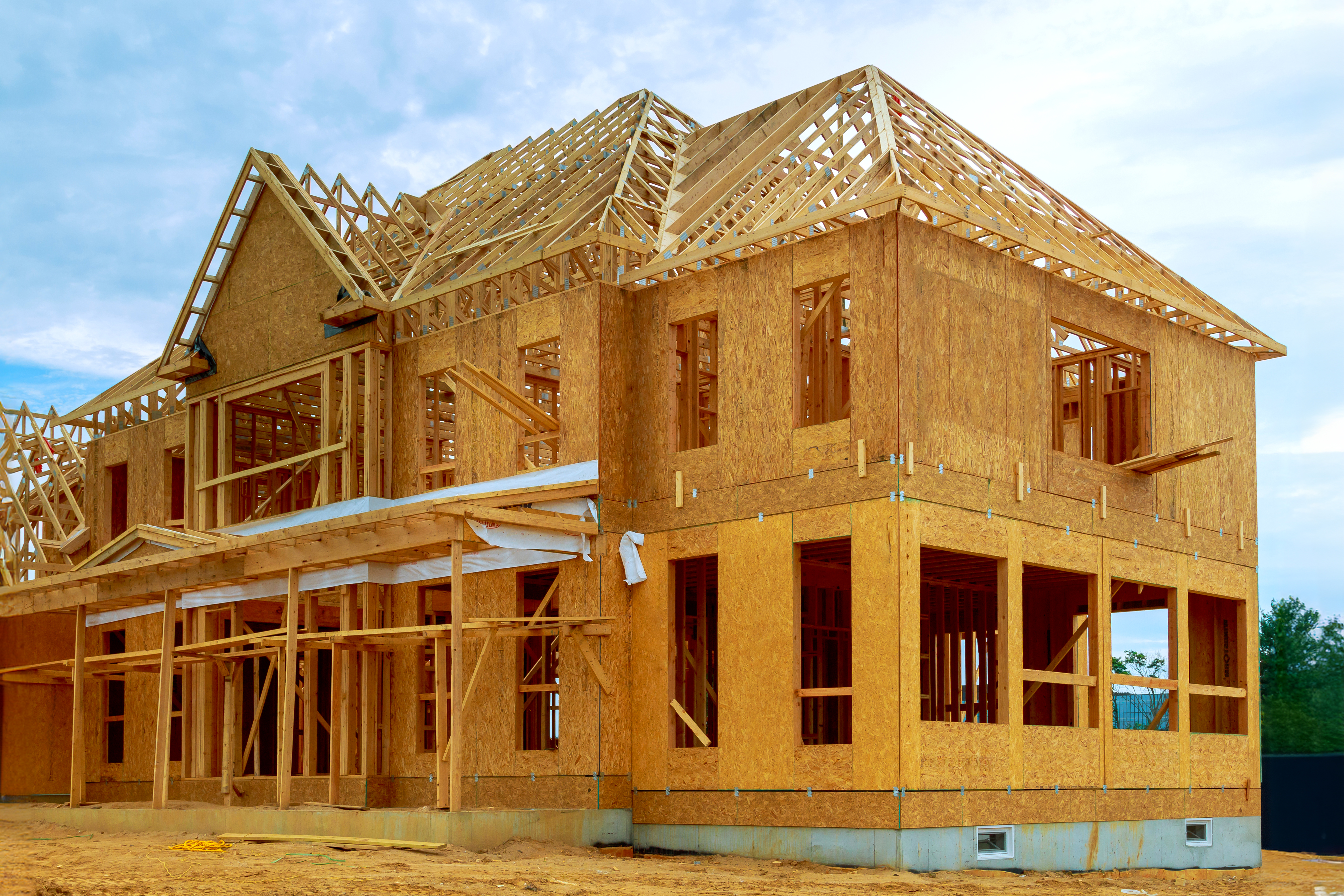 Two story home exterior with a newly added second floor, matching materials, blue sky