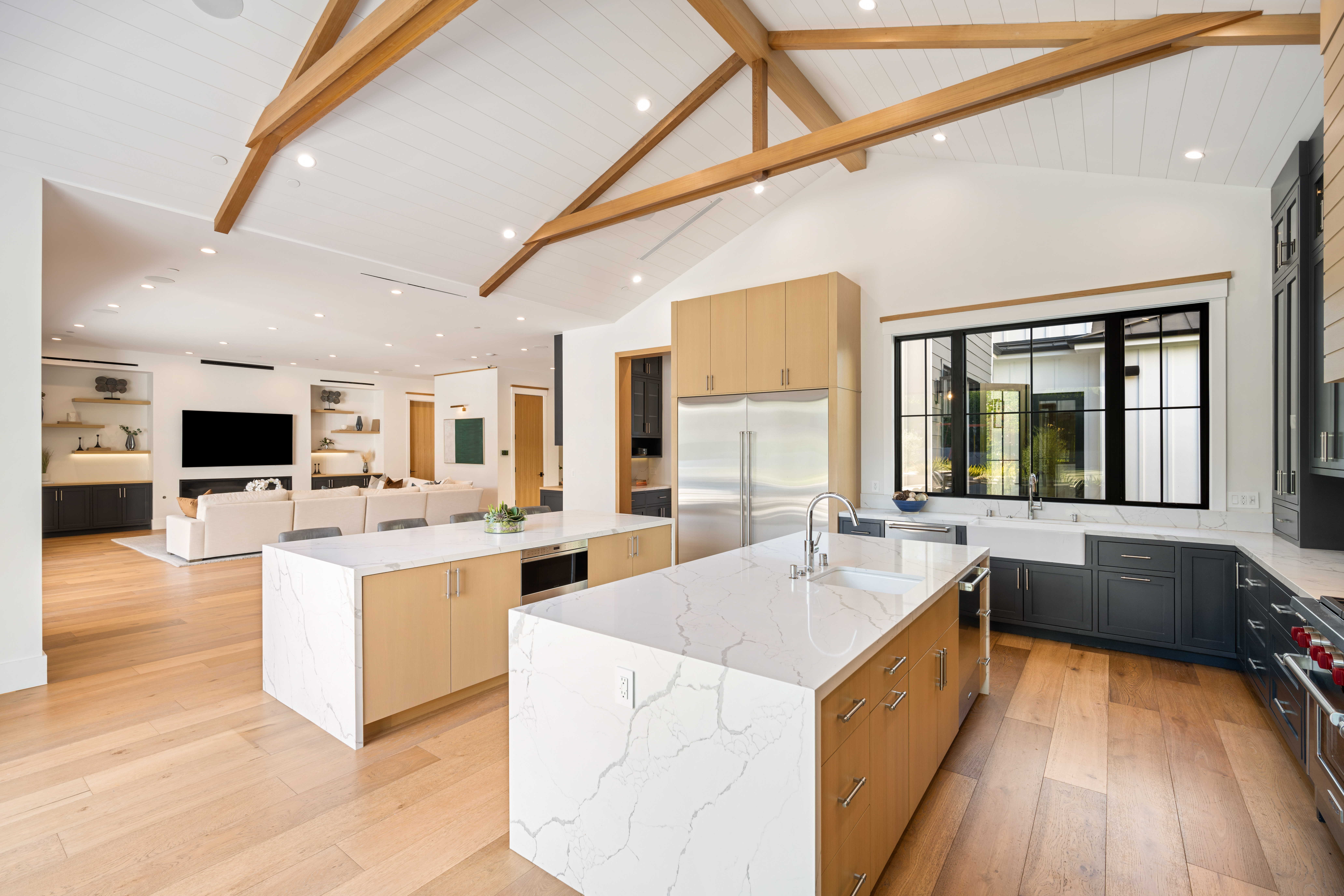 Renovated open concept home interior with new kitchen and living space, warm natural light