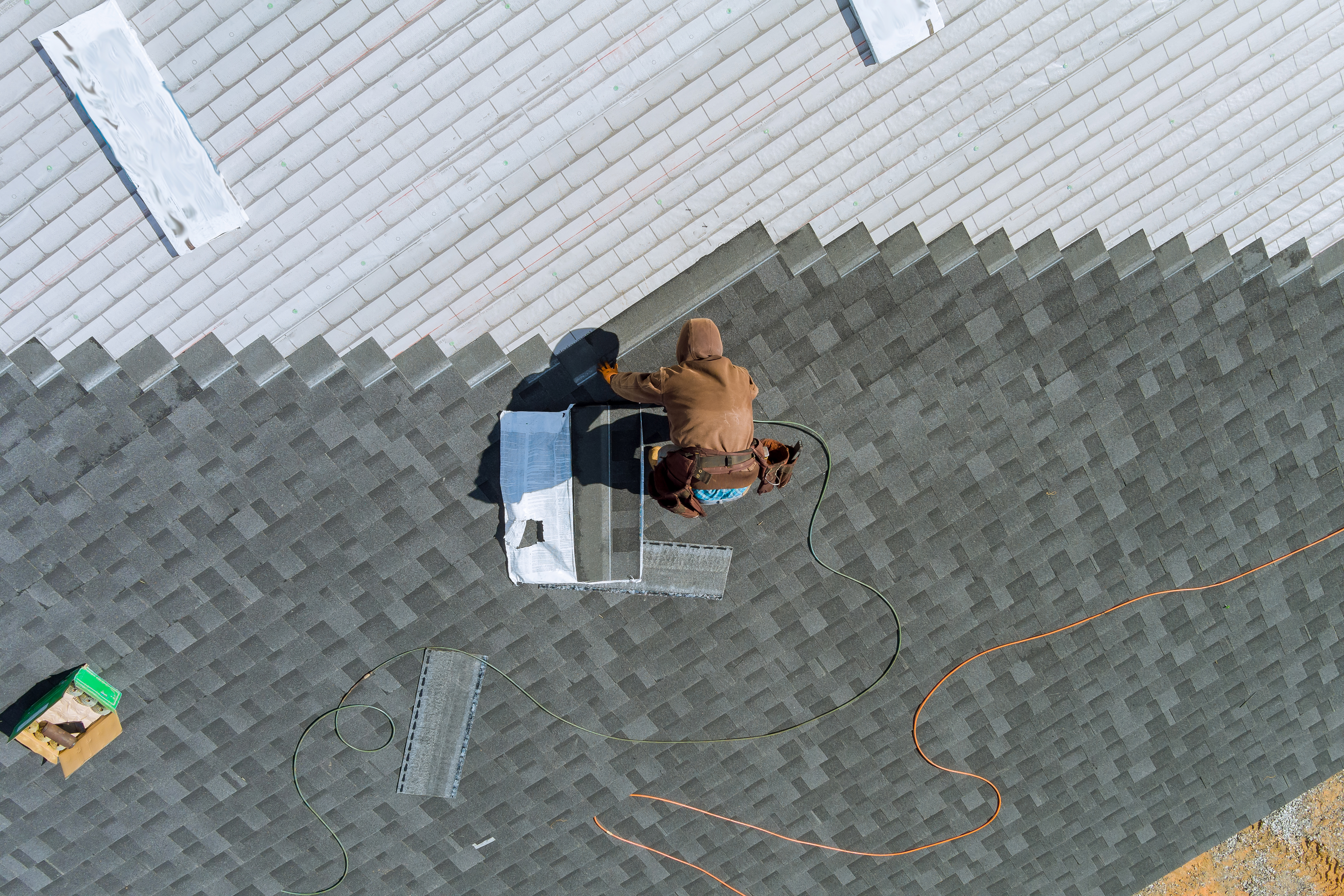 Crew installing a commercial TPO membrane roof