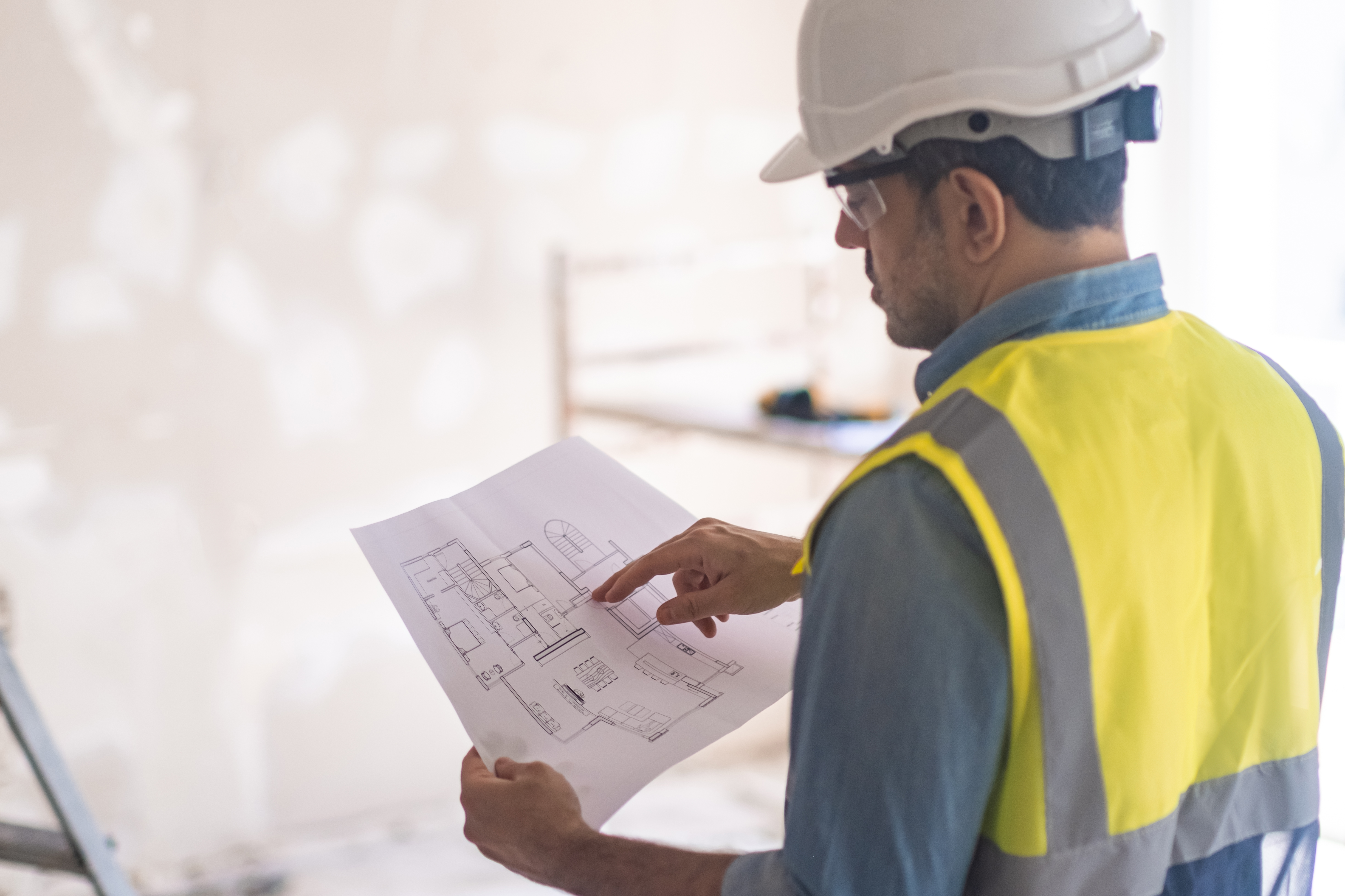 ZCI Group superintendent reviewing plans on site